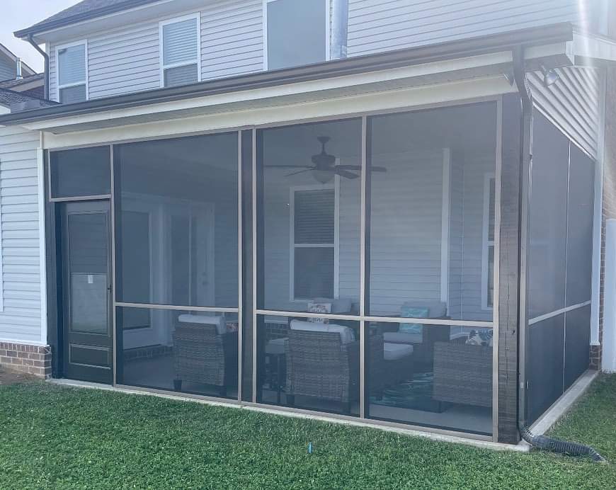 A screened in porch with a ceiling fan